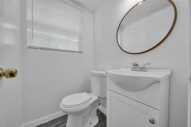 bathroom featuring vanity, toilet, and hardwood / wood-style flooring