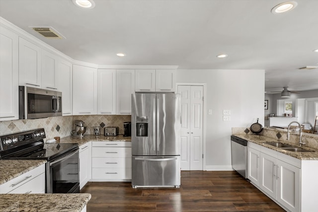 kitchen featuring dark hardwood / wood-style flooring, stainless steel appliances, white cabinetry, and sink