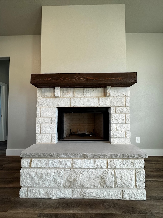 details with a stone fireplace and hardwood / wood-style flooring