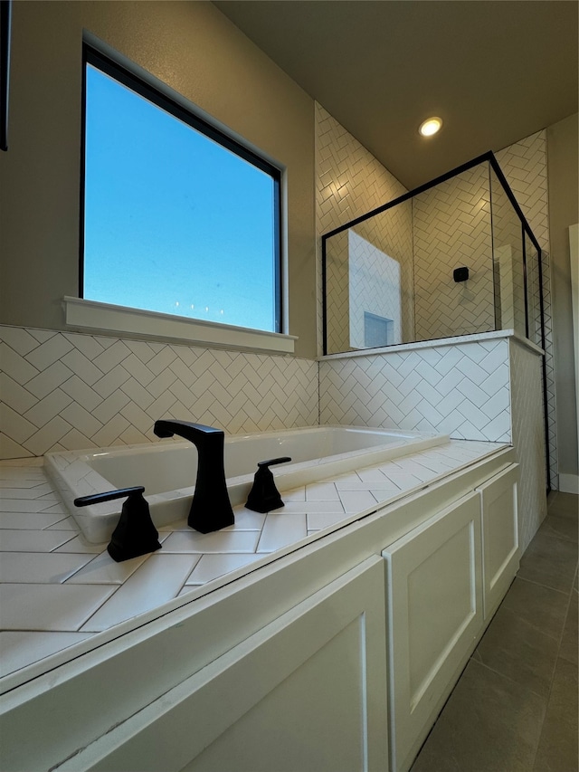 bathroom featuring plus walk in shower and tile patterned floors