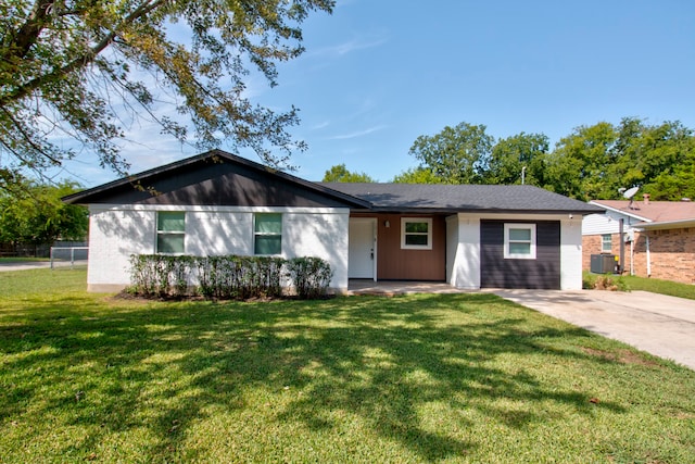 ranch-style home with cooling unit and a front lawn