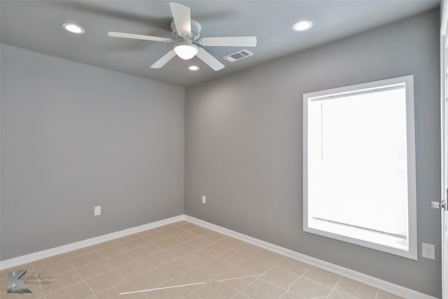 tiled empty room with ceiling fan