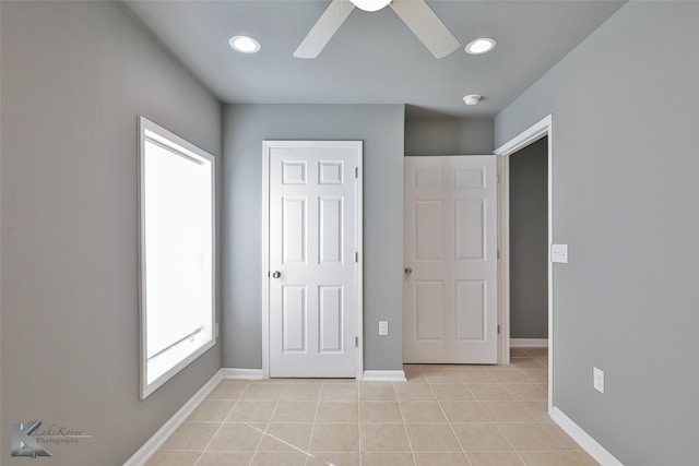 unfurnished bedroom with ceiling fan and light tile patterned floors