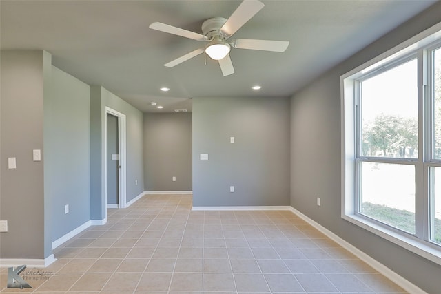 unfurnished room with ceiling fan and light tile patterned floors