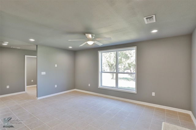 unfurnished room featuring light tile patterned floors and ceiling fan