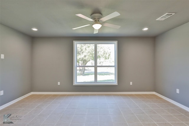 spare room featuring ceiling fan and light tile patterned floors