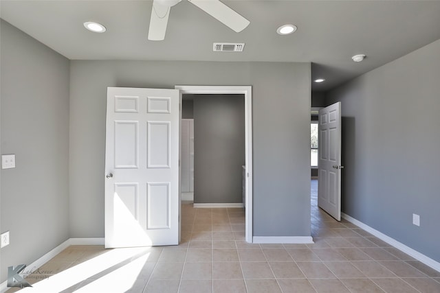 unfurnished bedroom with ceiling fan and light tile patterned floors