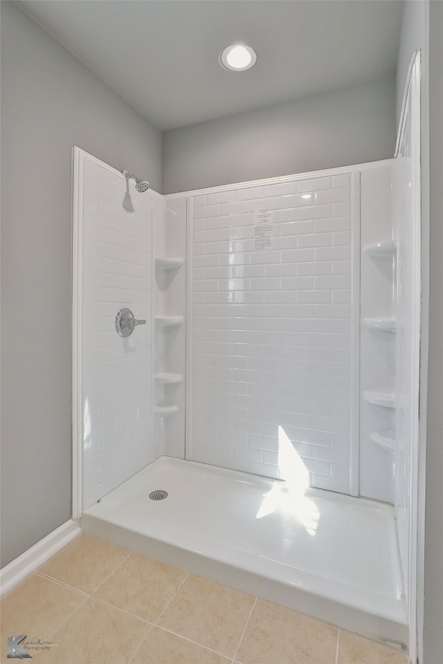 bathroom featuring a tile shower and tile patterned floors