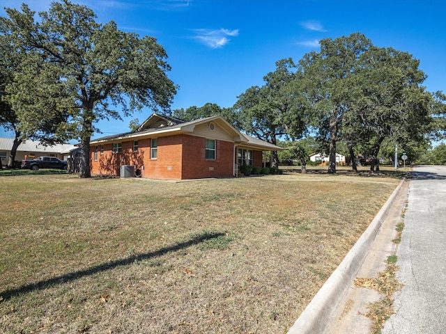 view of home's exterior with a lawn and central air condition unit