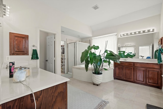 bathroom with shower with separate bathtub, tile patterned flooring, and vanity