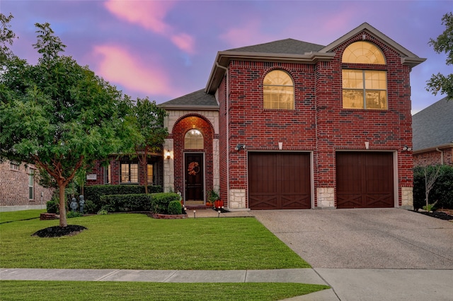 view of front of house with a yard and a garage