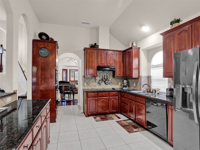 kitchen with stainless steel fridge, light tile patterned floors, sink, tasteful backsplash, and dishwasher