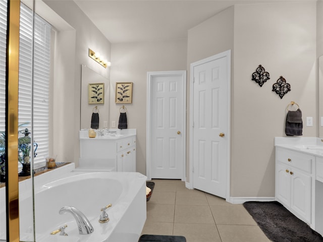 bathroom featuring vanity, tile patterned floors, and a tub