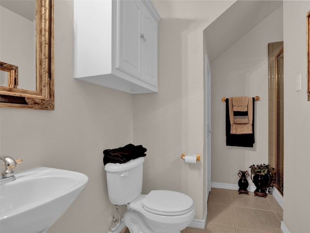 bathroom with walk in shower, sink, toilet, and tile patterned floors