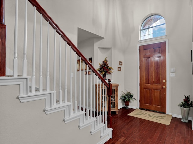 entryway featuring a high ceiling and dark hardwood / wood-style floors