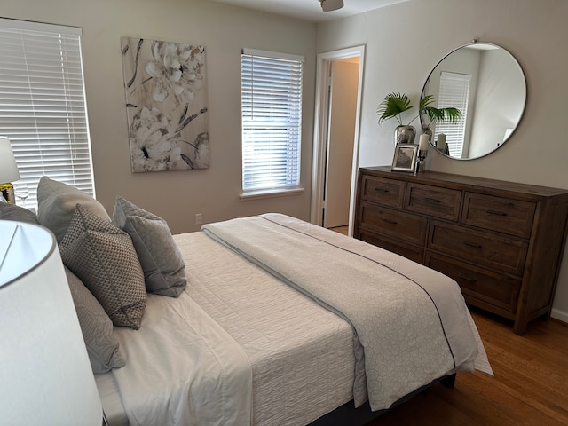 bedroom with dark wood-type flooring