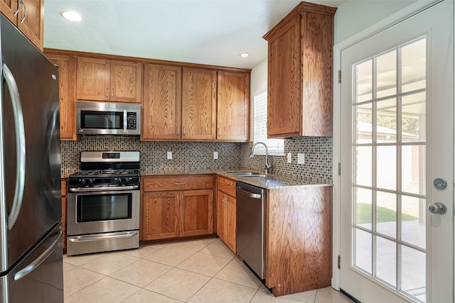 kitchen featuring stainless steel appliances, a healthy amount of sunlight, and sink