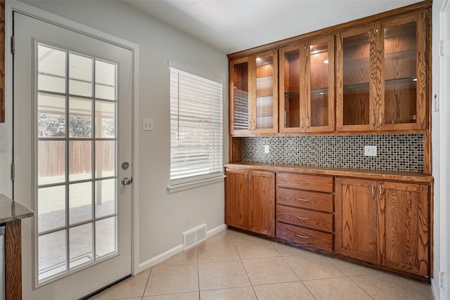 kitchen with light tile patterned floors and decorative backsplash