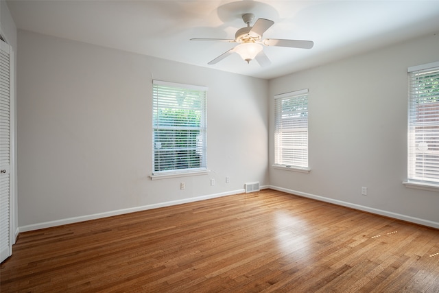 spare room with light hardwood / wood-style floors and ceiling fan