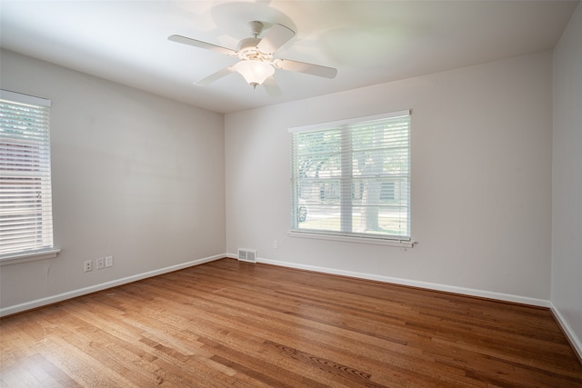 spare room featuring hardwood / wood-style floors and ceiling fan