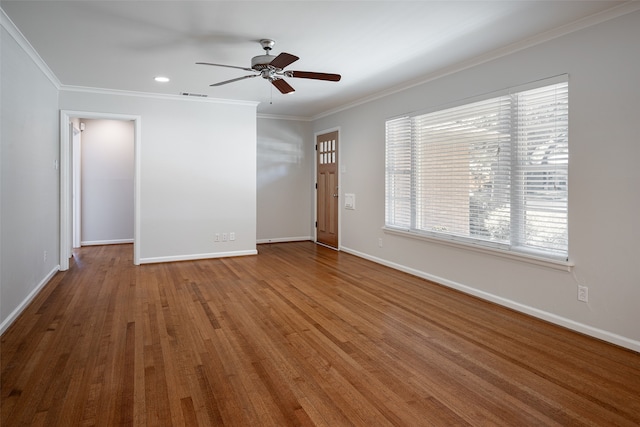 empty room featuring ornamental molding, hardwood / wood-style floors, and ceiling fan