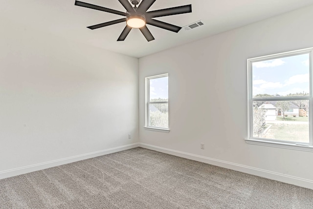 carpeted empty room with a healthy amount of sunlight and ceiling fan