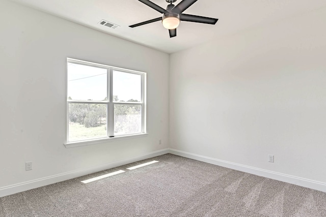 spare room featuring carpet floors and ceiling fan