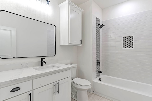 full bathroom with vanity, tiled shower / bath combo, and toilet