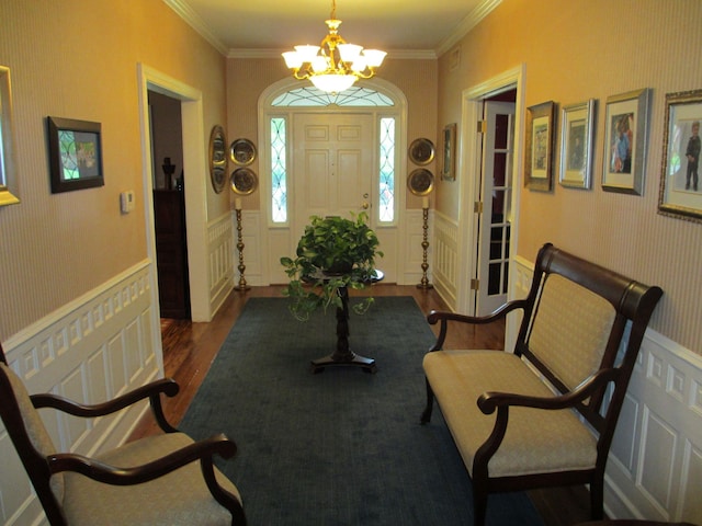 401 Craig St, Hillsboro, TX 76645 - entrance foyer featuring a chandelier, dark wood finished floors, crown molding, and wainscoting