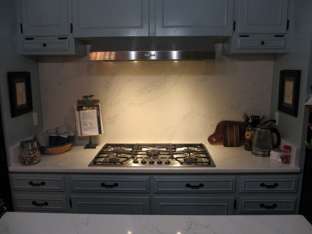 401 Craig St, Hillsboro, TX 76645 - kitchen featuring backsplash, light stone counters, stainless steel gas stovetop, and ventilation hood