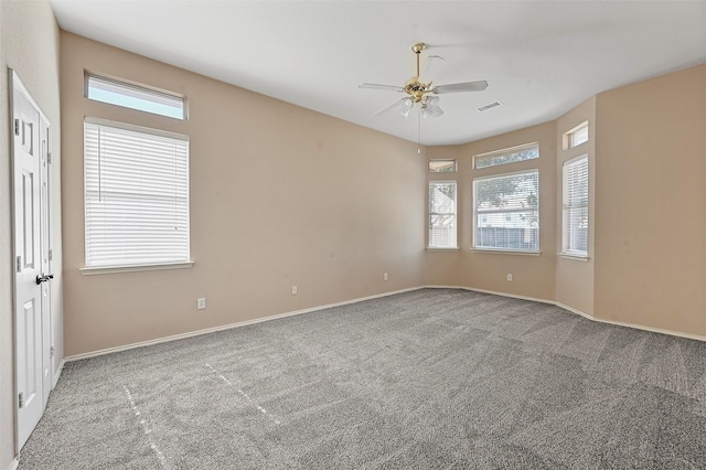 empty room featuring ceiling fan and carpet floors