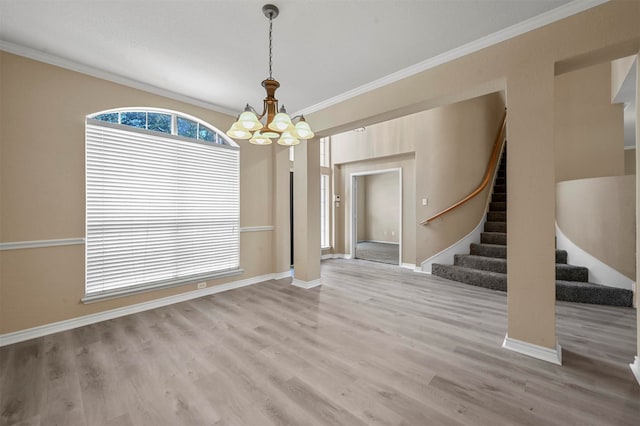 interior space featuring ornamental molding, hardwood / wood-style floors, and a chandelier