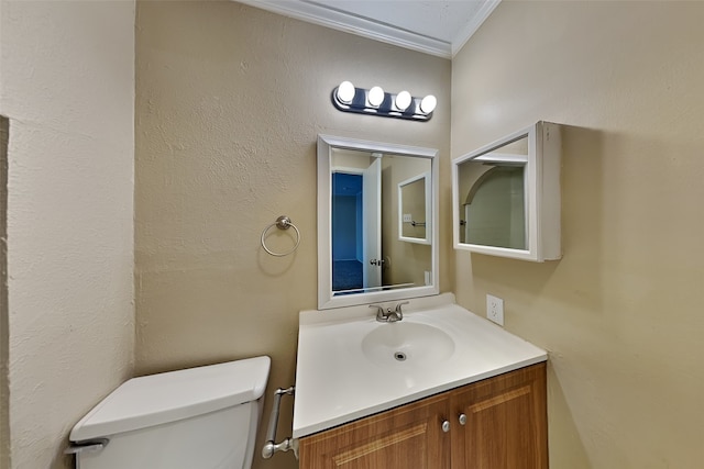 bathroom featuring ornamental molding, vanity, and toilet