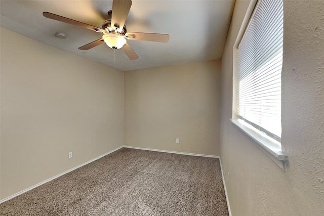 spare room with ceiling fan and carpet floors