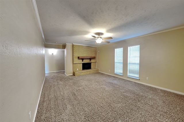 unfurnished living room with ceiling fan, ornamental molding, a brick fireplace, a textured ceiling, and carpet