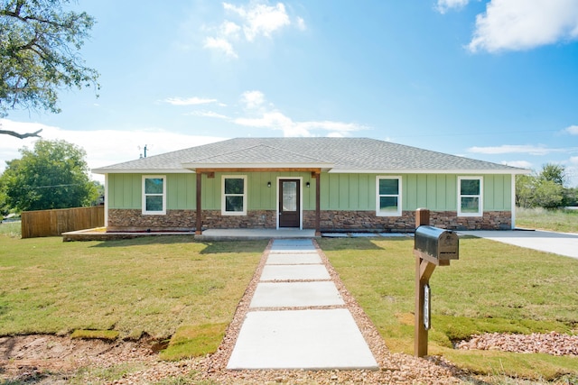 ranch-style house with a front yard and a porch