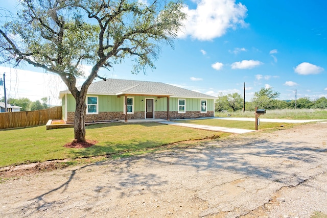 ranch-style home with a front lawn