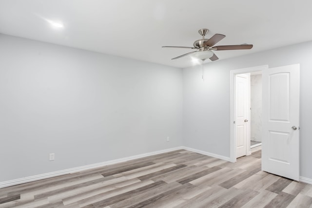 spare room featuring light hardwood / wood-style flooring and ceiling fan