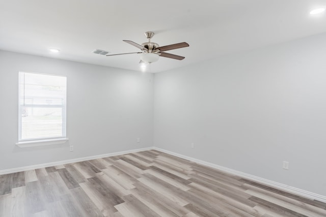 spare room featuring light hardwood / wood-style floors and ceiling fan