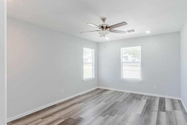 empty room featuring ceiling fan and light hardwood / wood-style floors