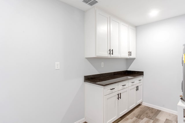 clothes washing area featuring light hardwood / wood-style floors