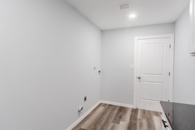 clothes washing area featuring wood-type flooring, electric dryer hookup, and hookup for a washing machine