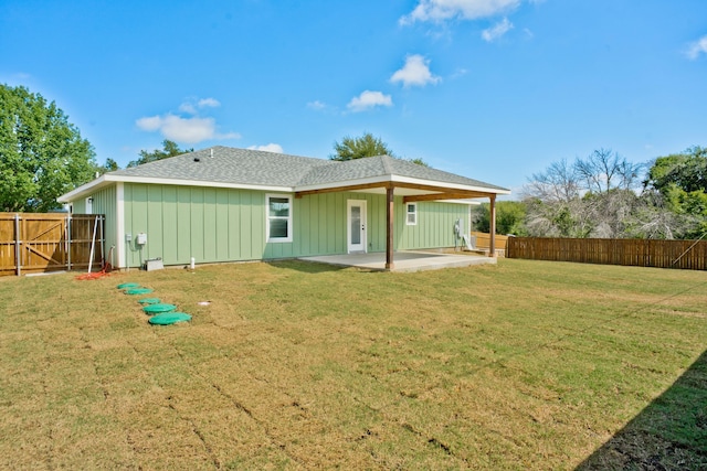 back of property featuring a patio and a lawn