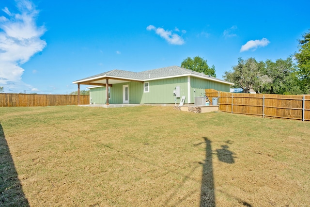 rear view of house with a yard