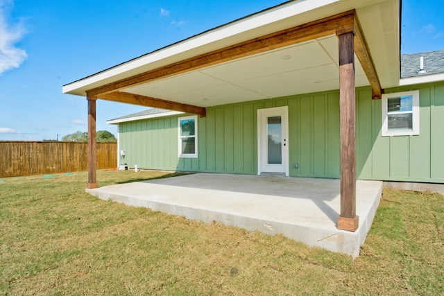 rear view of house featuring a yard and a patio area