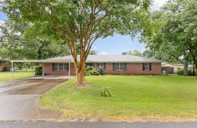 ranch-style house featuring a carport and a front yard