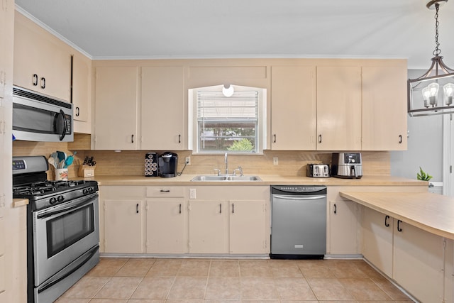 kitchen featuring sink, a notable chandelier, hanging light fixtures, stainless steel appliances, and light tile patterned floors