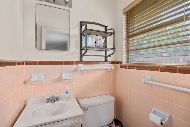 bathroom with vanity, toilet, and plenty of natural light