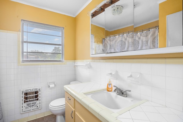 bathroom with tile walls, heating unit, vanity, tile patterned flooring, and toilet