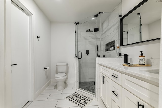 bathroom with tile patterned flooring, a shower with door, vanity, and toilet